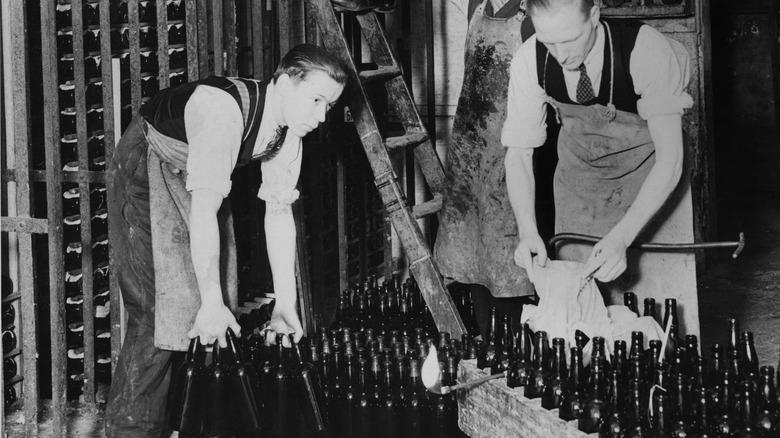 workers moving bottled wine