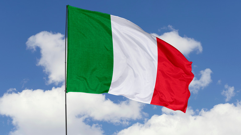 Italian flag waving in blue sky