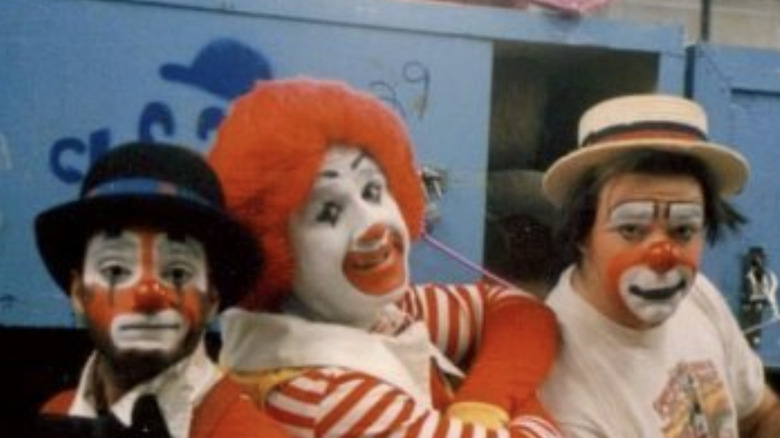 Aye Jaye as Ronald McDonald in between two clowns