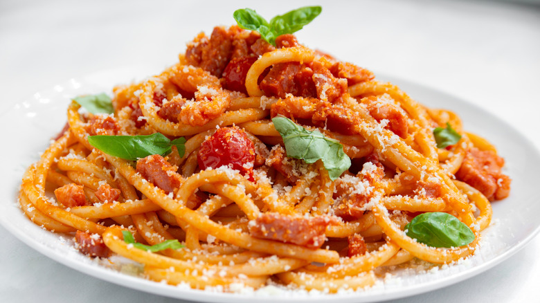 Pasta Amatriciana with tomatoes, grated cheese, and basil