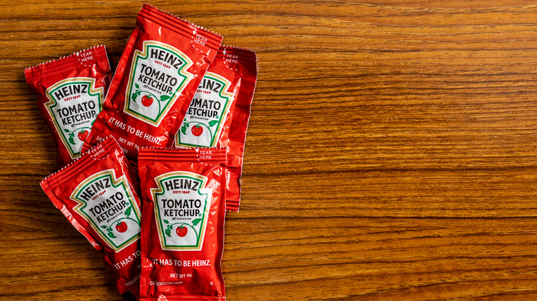 Heinz ketchup packets on wood background