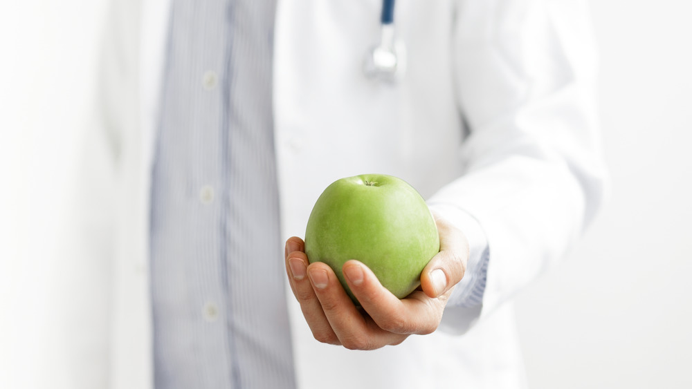 Doctor holding apple