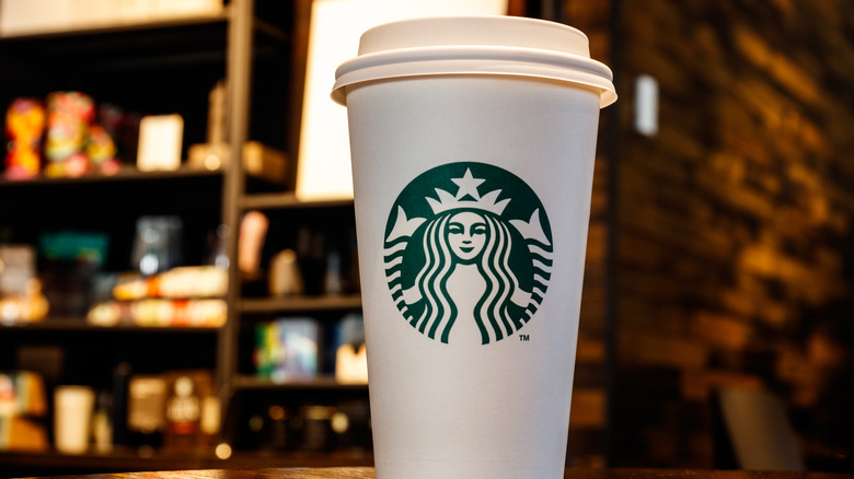 White to-go coffee cup with Starbucks green logo.