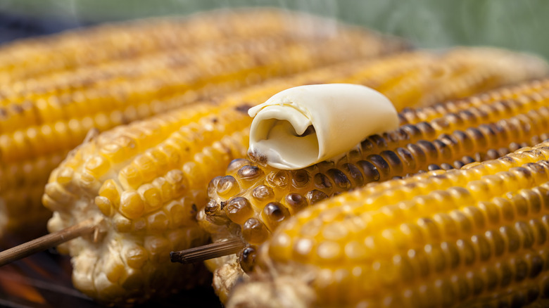 Corn with butter cooking on grill 