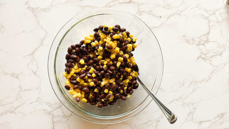 black beans and corn in a clear glass bowl