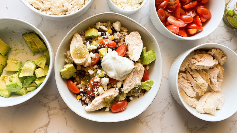 all ingredients assembled in the bowl, with salsa verde on top