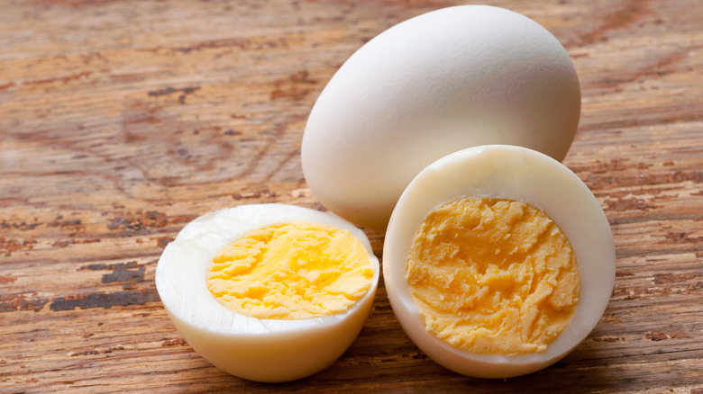 Hard-boiled eggs on wooden surface