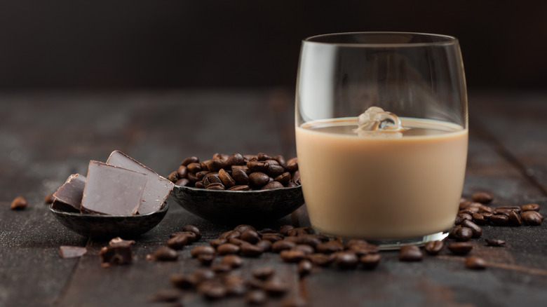 Glass of Baileys next to coffee beans