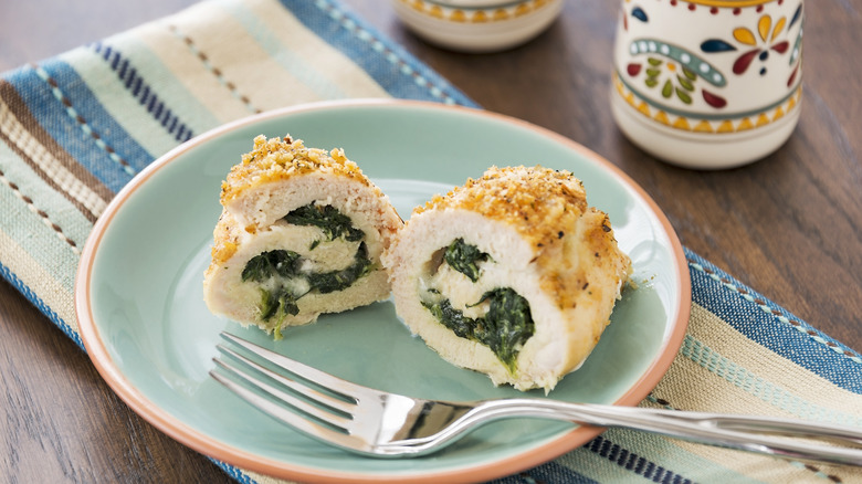 closeup of cut chicken breast stuffed with spinach