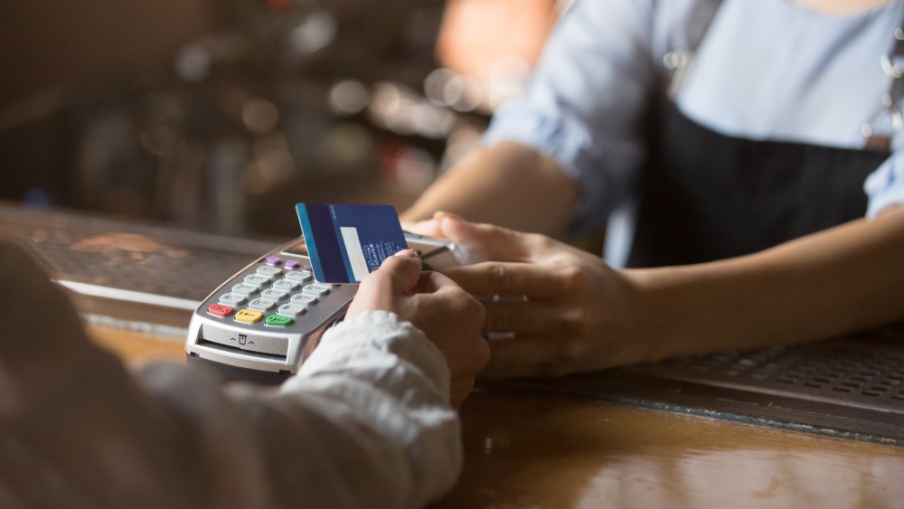 A generic image of a customer paying at a cash counter