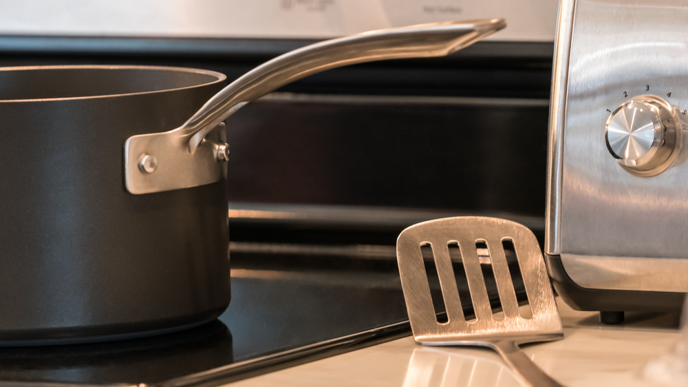 Pot on stovetop with metal spatula