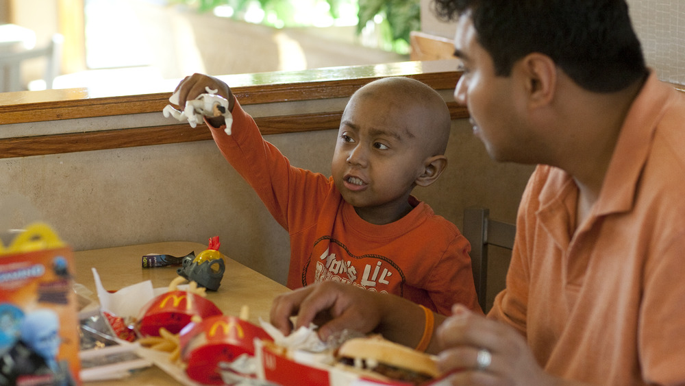 child and father with happy meal