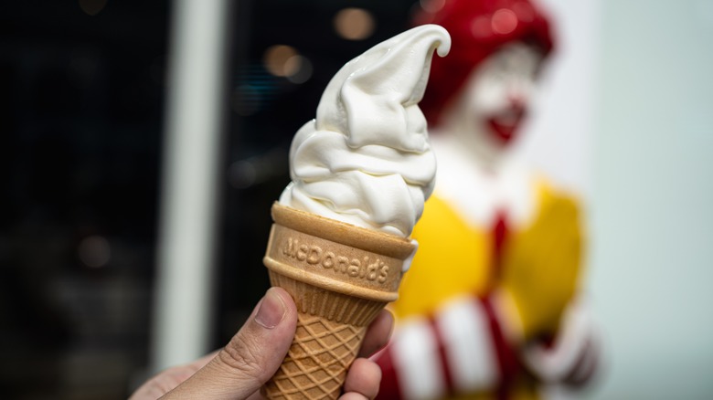 Person holding McDonald's ice cream cone