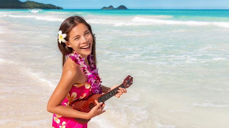 girl on beach with ukulele