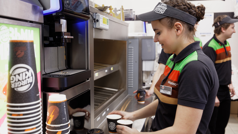 Burger King worker with cups