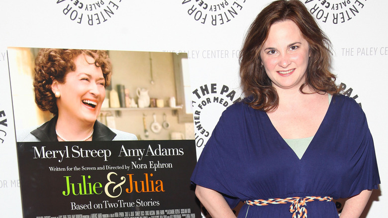 Julie Powell standing with Julie and Julia poster