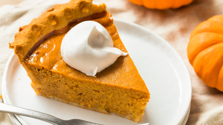 pumpkin pie slice with whipped cream