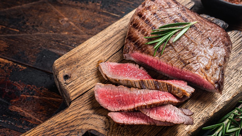 Sliced flank steak on wood