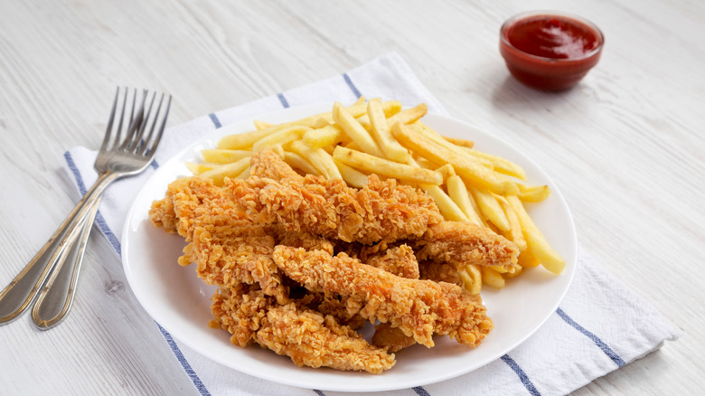 plate of chicken tenders and fries