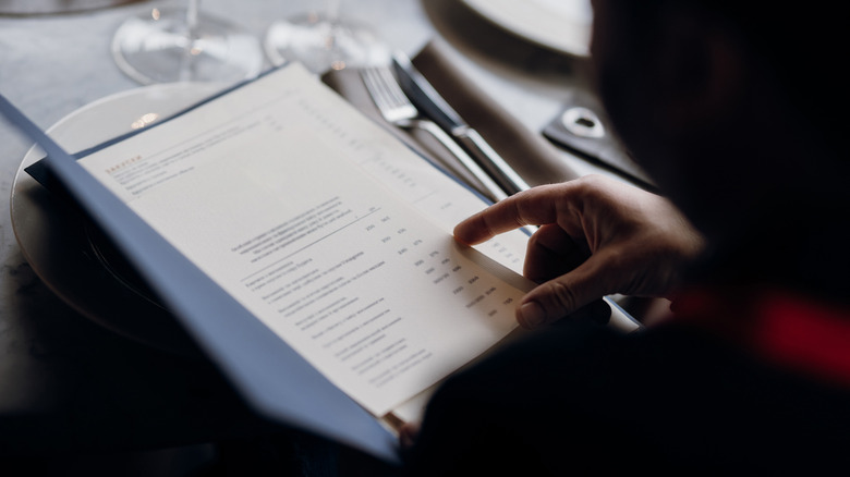 Person reading a restaurant menu