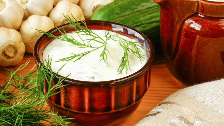 bowl of tzatziki topped with fresh herbs