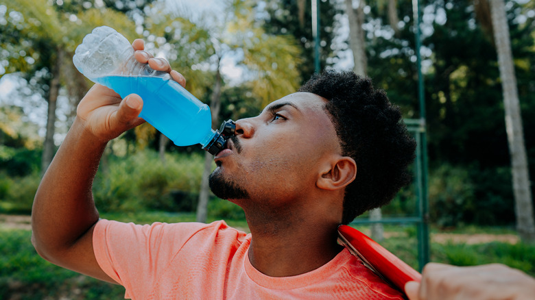 Man drinking blue sports drink