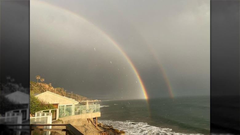 Double Rainbow over beach with house and ocean