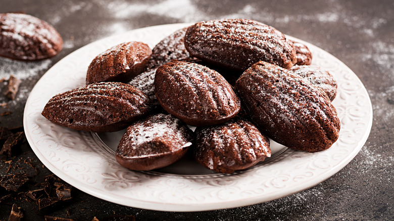 Chocolate madeleines on white plate