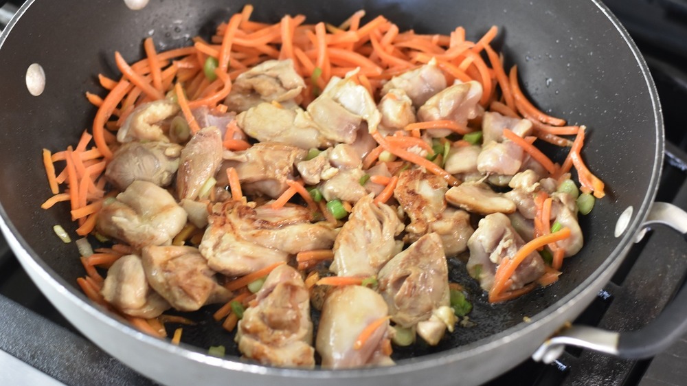 drunken noodles cooking in pan