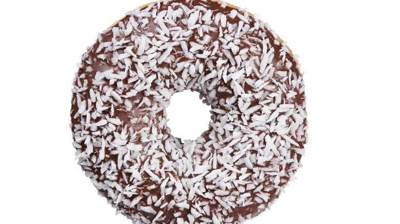 Chocolate coconut donut on white background