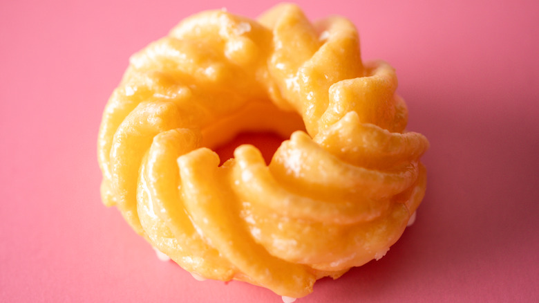 French cruller on pink background