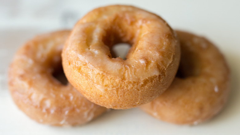 Three sour cream donuts on white background