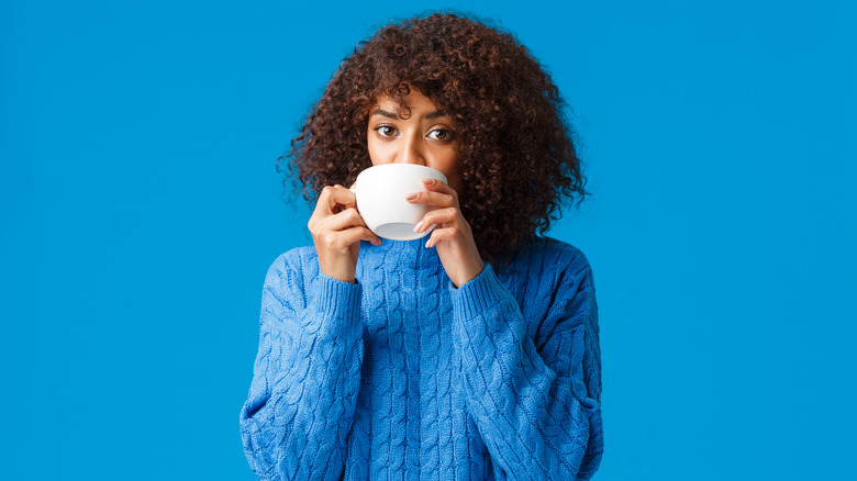 Woman sips coffee