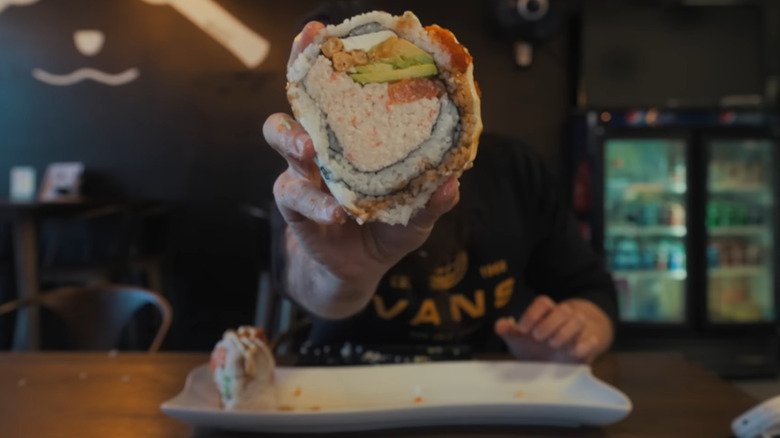 Moran holding up sushi slice