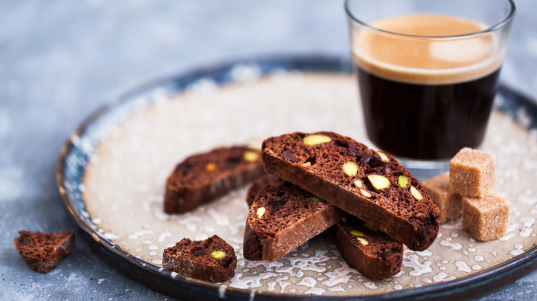 homemade chocolate biscotti on a plate with a shot of espresso