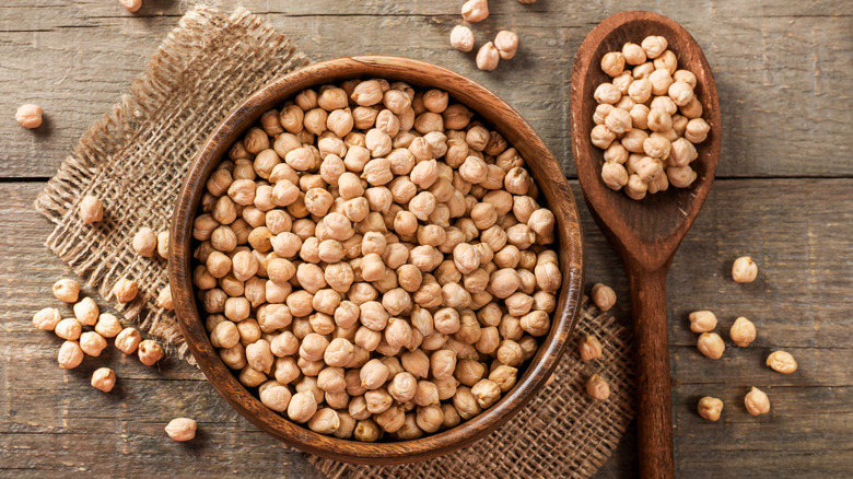 chickpeas in wooden bowl on wood table