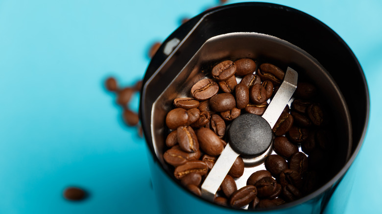 Closeup of coffee grinder with beans