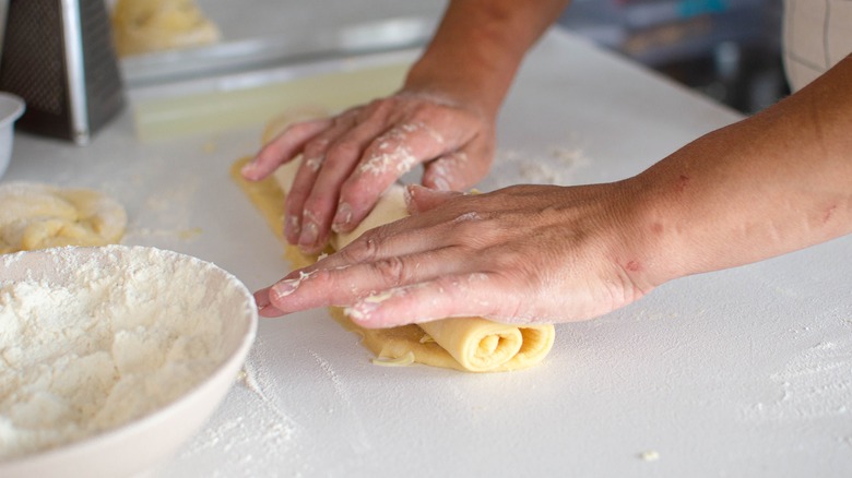 hands rolling out dough