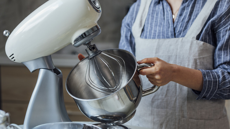 A woman using a stand mixer