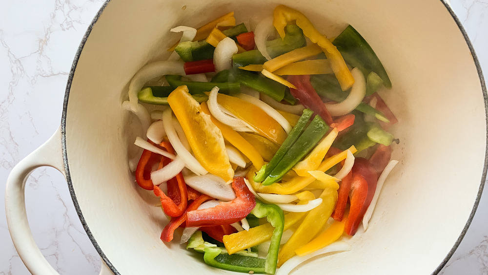 cooking onion and peppers for easy chicken fajita pasta