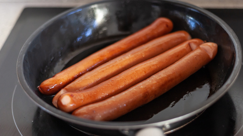 Brown hot dogs in skillet