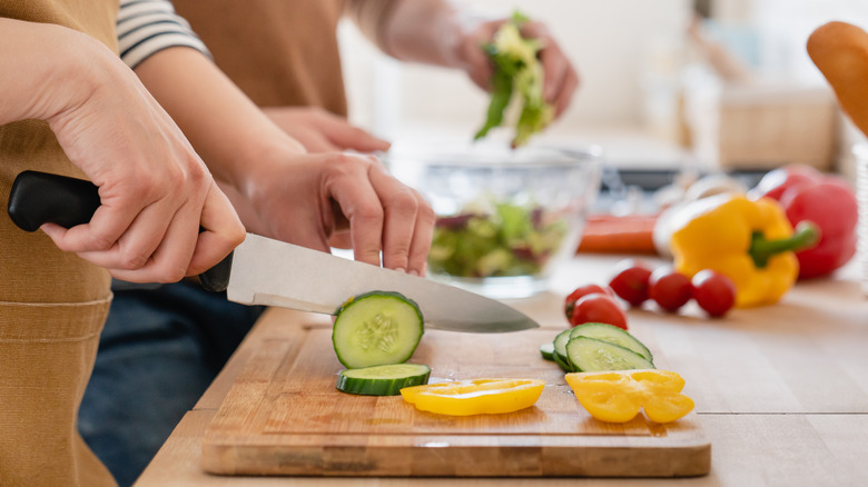 home cooks cutting fresh vegetables 