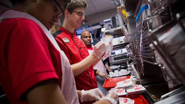 Chick-fil-A employee handles chicken sandwich