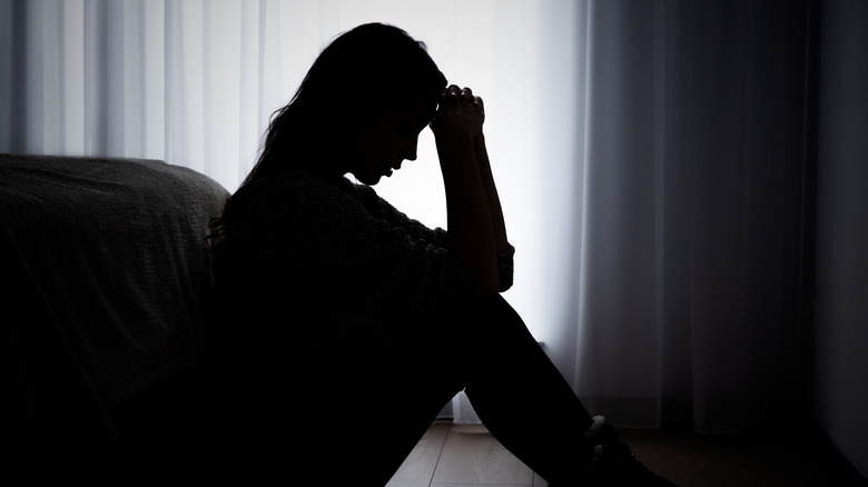 woman depressed in dark room