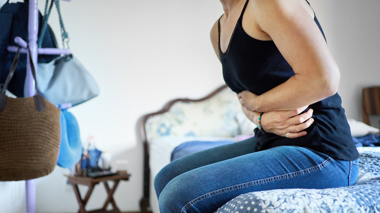 woman holding upset stomach from constipation