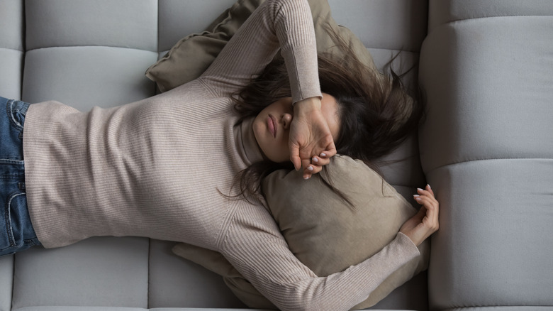 woman exhausted on couch