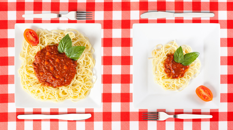 spaghetti and sauce two white plates