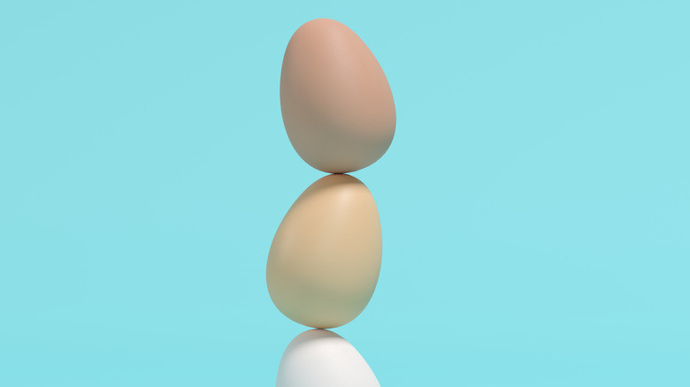 Stacked eggs on blue background