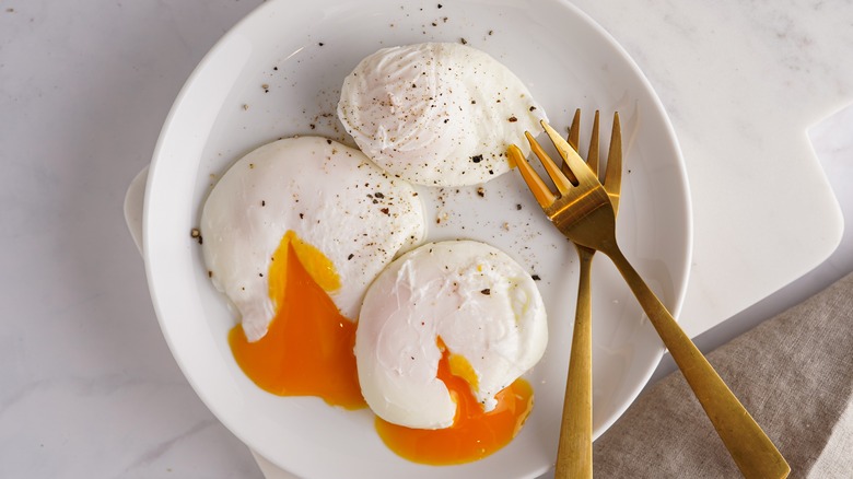 poached eggs on plate with forks