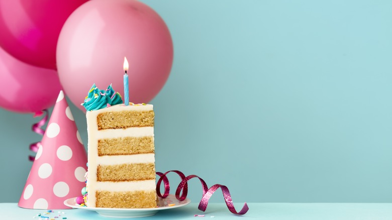 slice of birthday cake with balloons